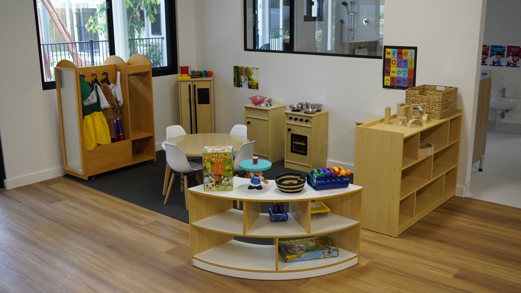 Home-corner role play area with dress-ups and play kitchen at Greenbank Covella