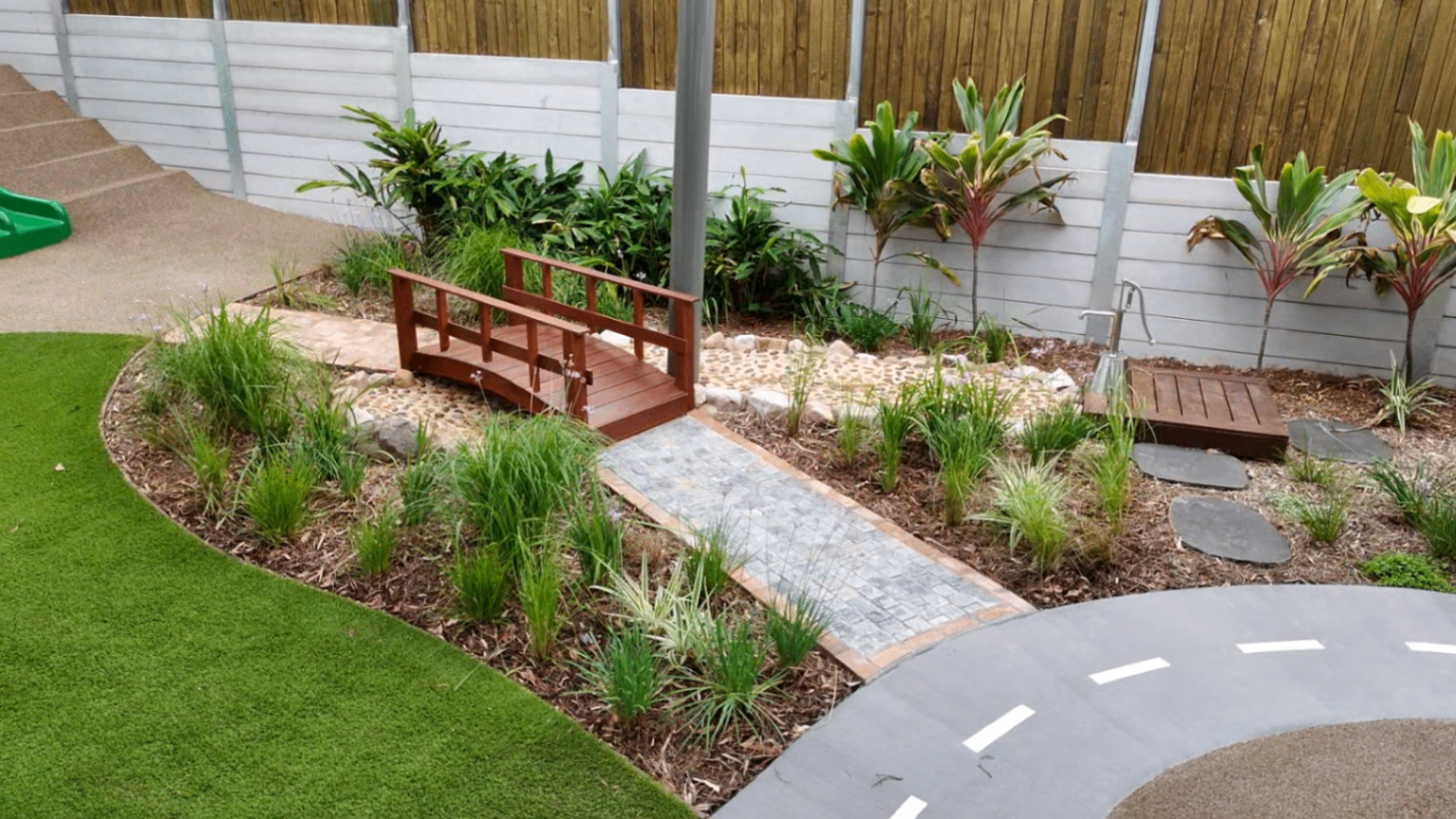 Sensory garden with wooden bridge and tropical plants at Greenbank Covella