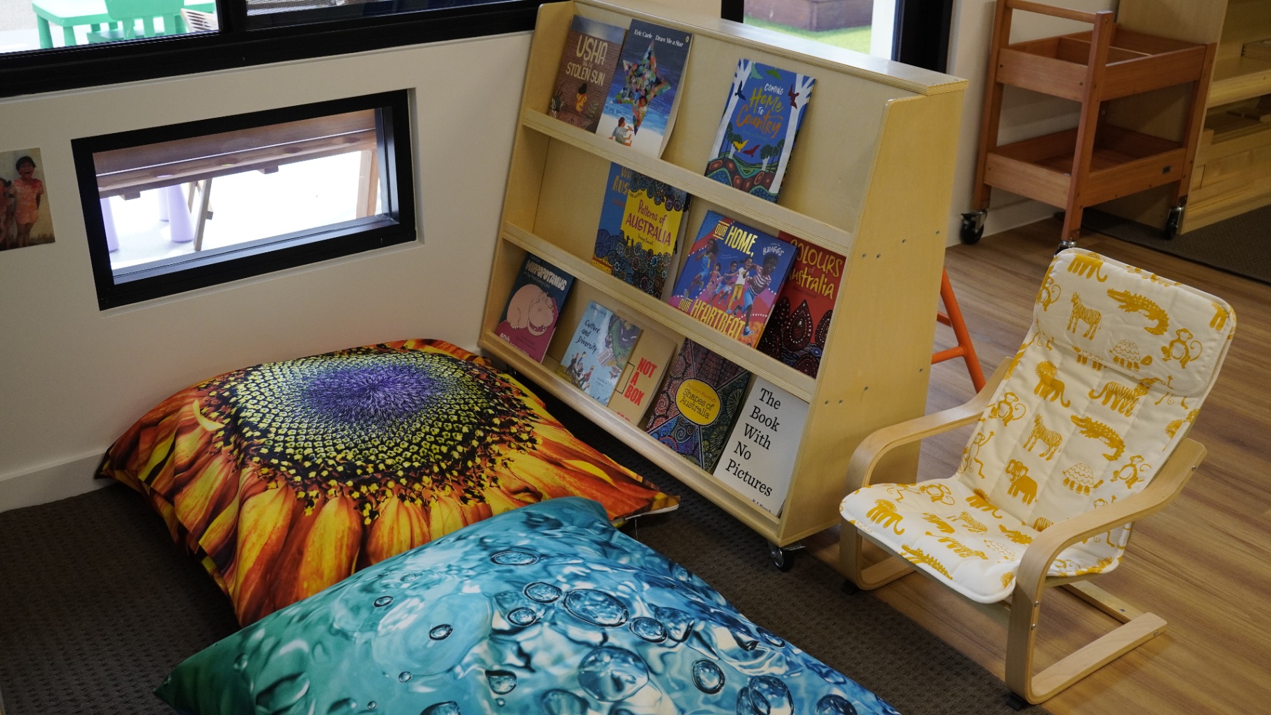 Quiet reading nook with floor cushions and picture-book display at Greenbank Covella