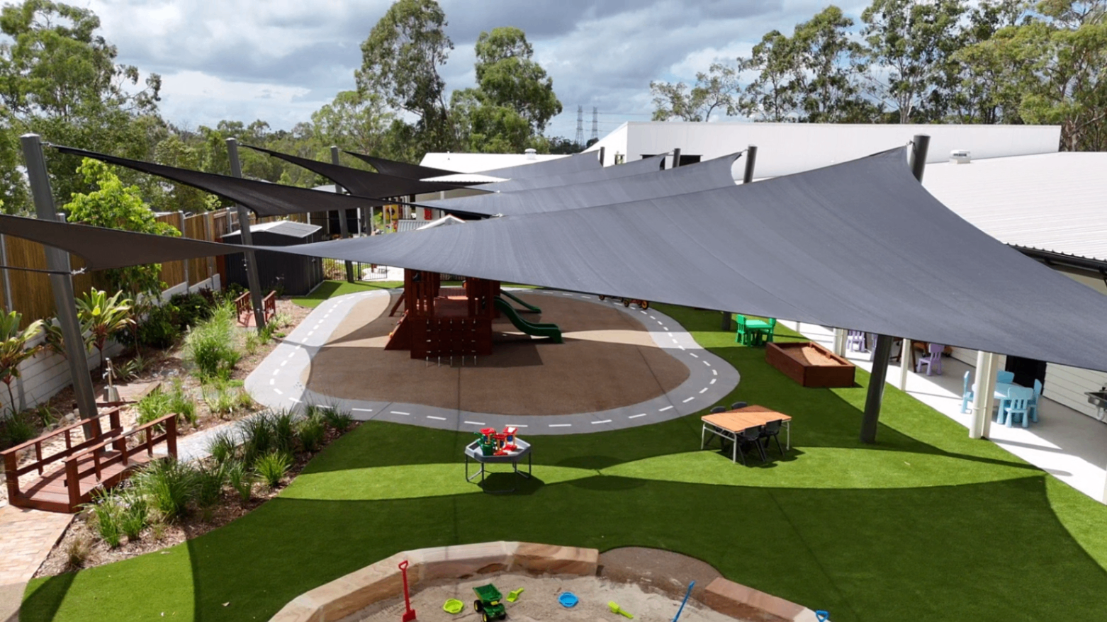 Aerial view of the Greenbank Covella outdoor playground with shade sails and play roadway